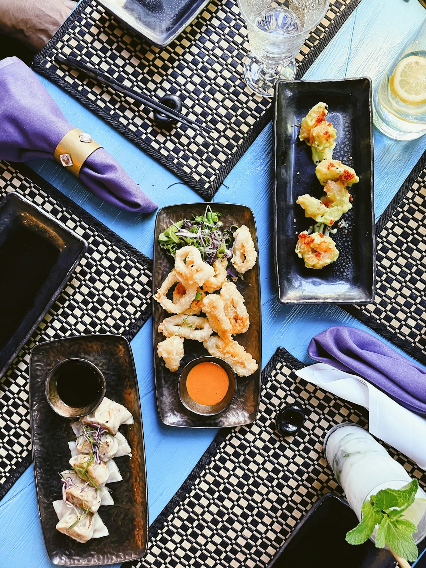 Shared table spread of Japanese small plates